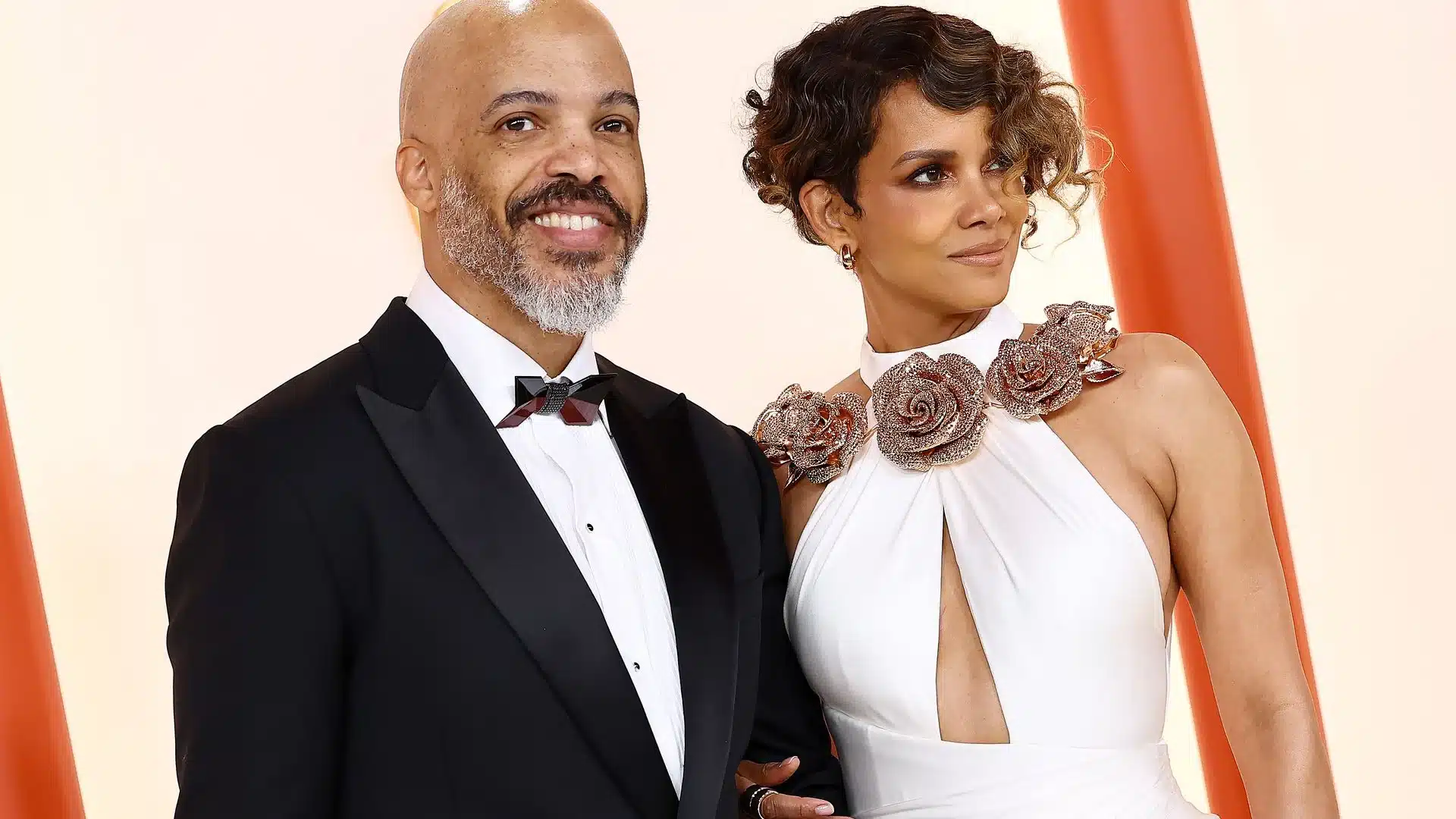 Halle Berry smiling at an event, known for her iconic roles in Hollywood films.